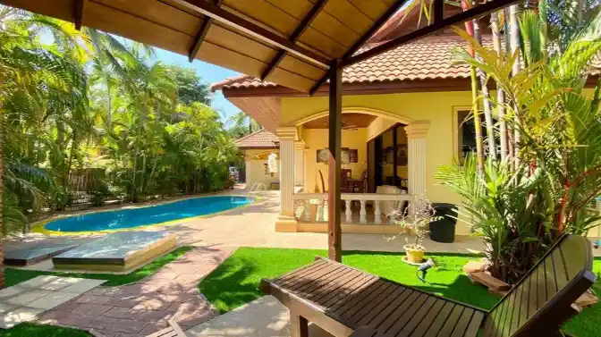 Coconut Paradise Villa lush garden beside pool