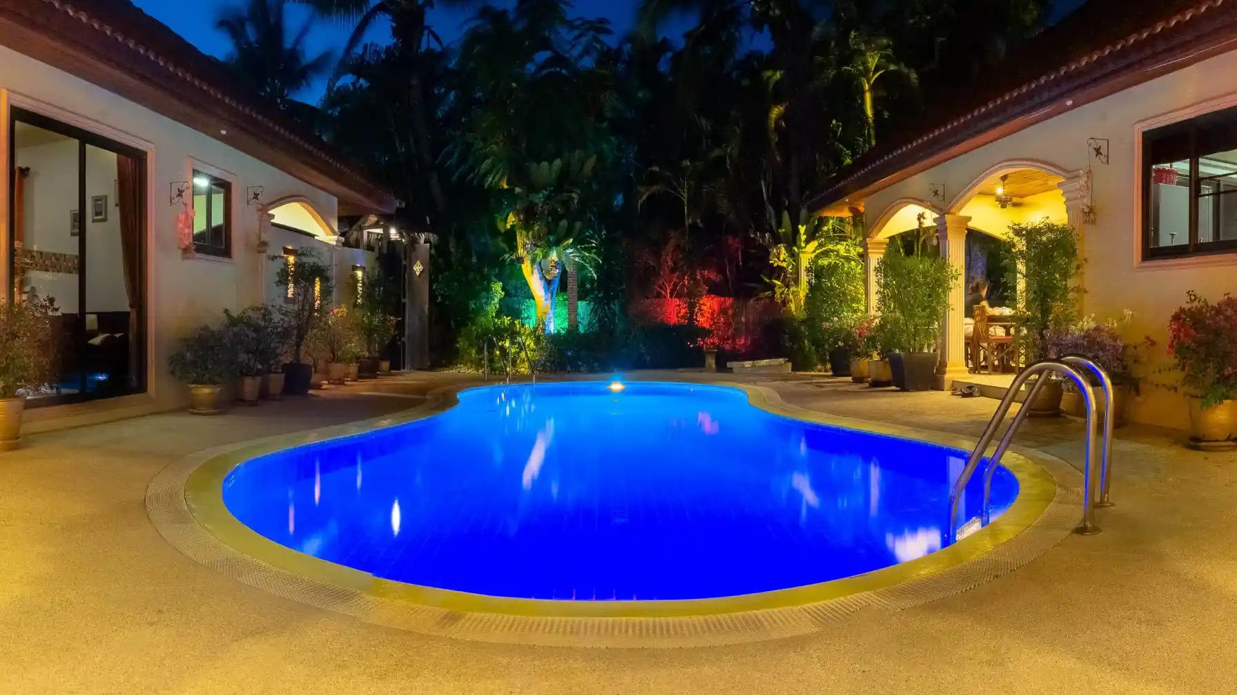 The Coconuts Villa garden area with pool