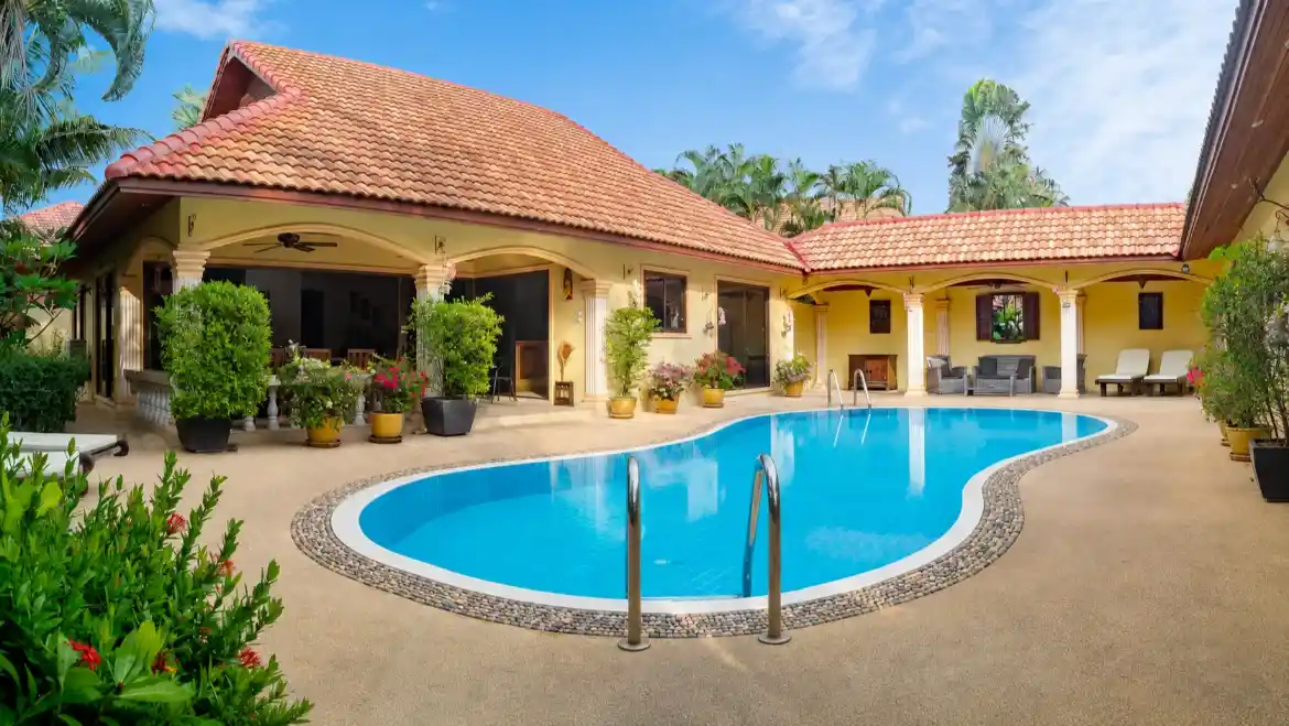 The Coconuts Villa pool with lounge chairs