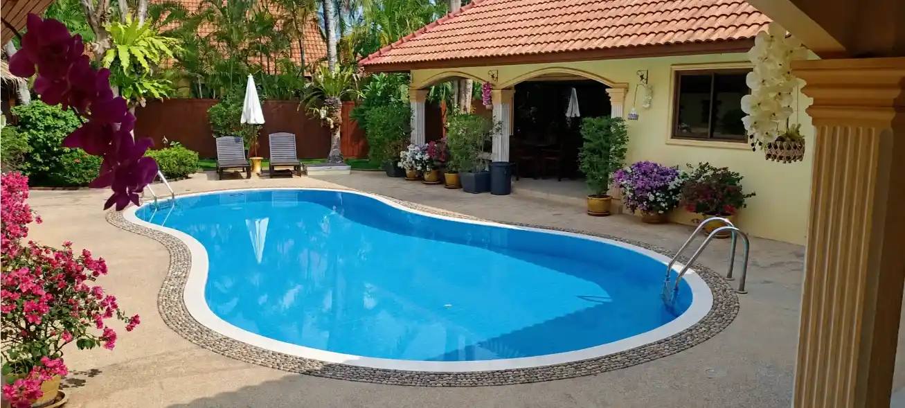 The Coconuts Villa pool and palm trees