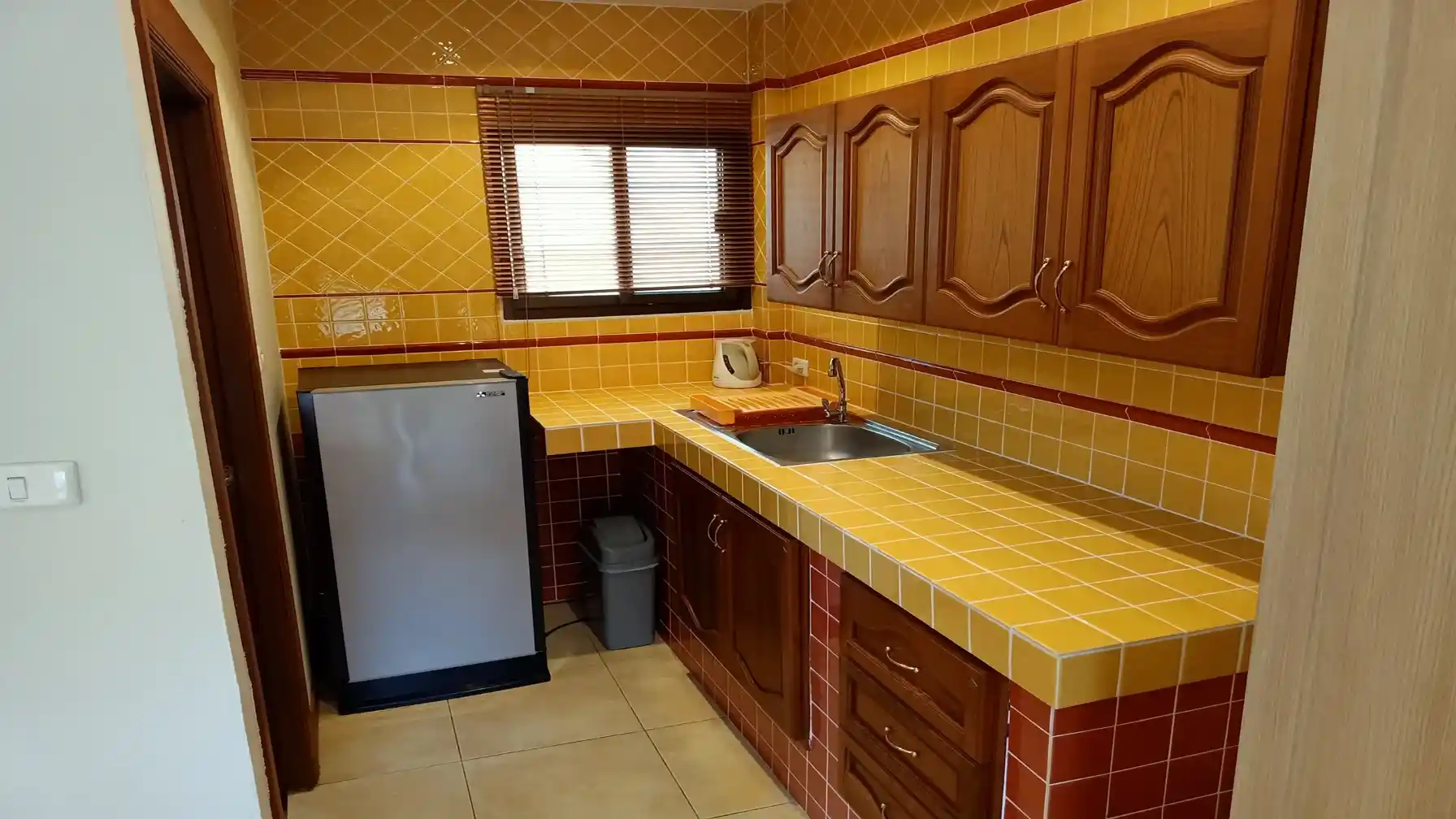 The Coconuts Villa studio kitchenette with fridge and sink